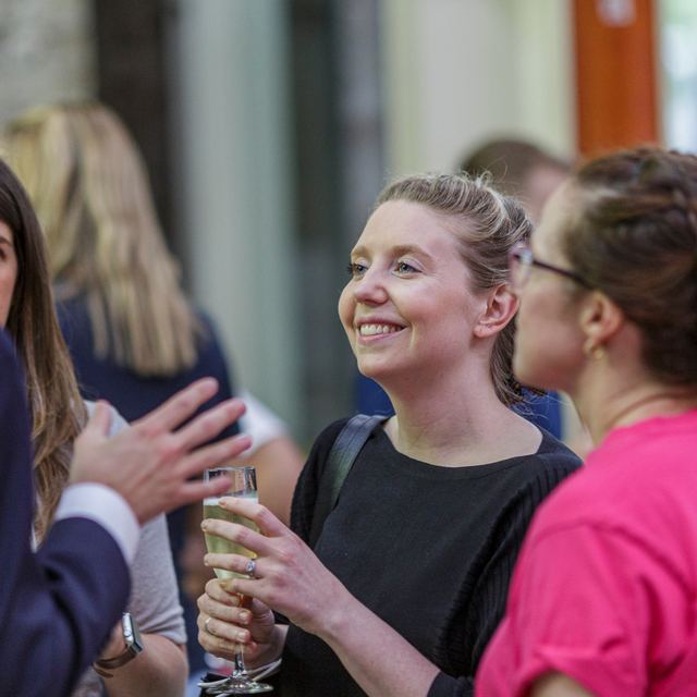 Two attendees talking over drinks at a Spark Festival event